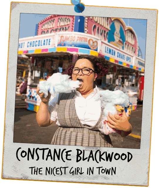 A taped polaroid picture of Constance Blackwood eating cotton candy. The handwritten text on the polaroid reads 'CONSTANCE BLACKWOOD, THE NICEST GIRL IN TOWN'